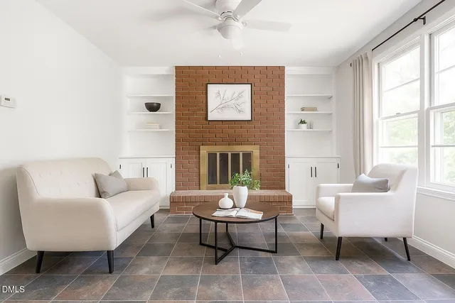 a living room with furniture a rug and a fireplace