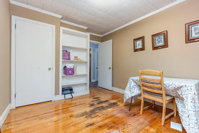 a bedroom with a bed and a chair in it