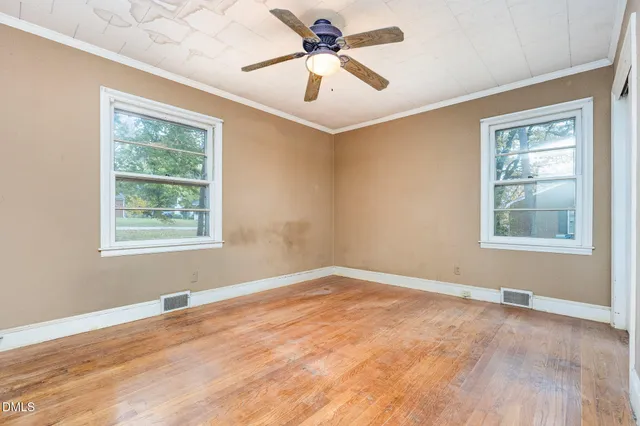 a view of a livingroom with a window and wooden floor