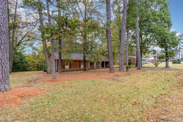 a view of a house with trees in the background