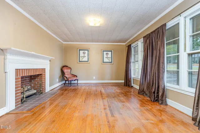 a view of a livingroom with a fireplace and a window