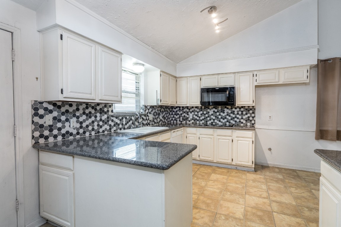 5018 Fitzwater Drive Spring, TX 77373 - Photo 13 of 27 Kitchen has been updated w/ granite counters & custom backsplash.