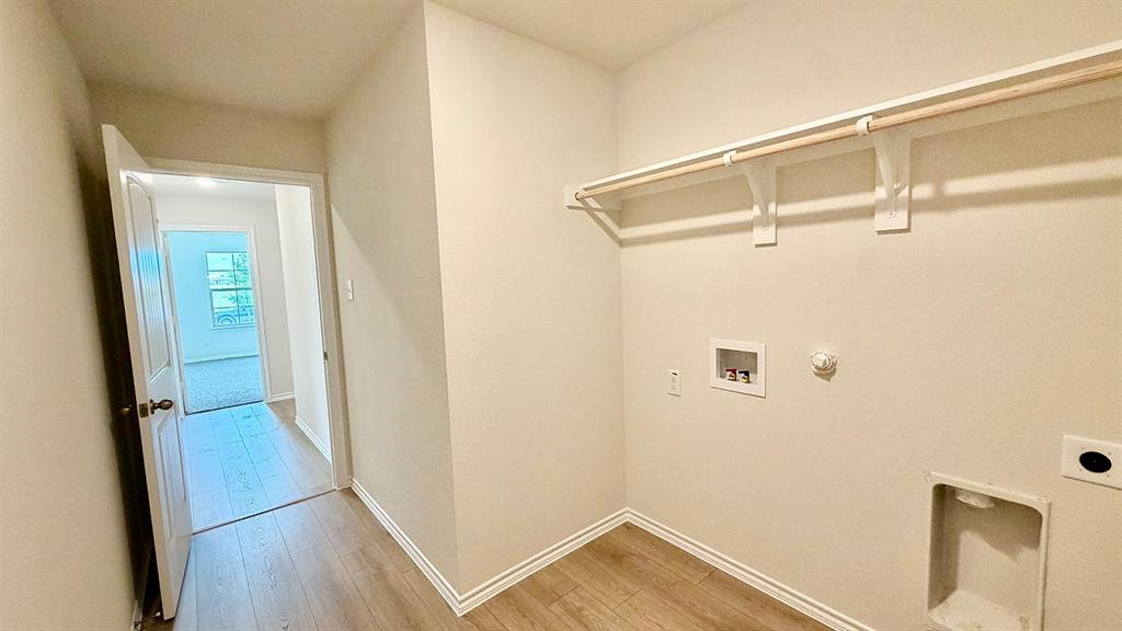 2003 Reveille Way Terrell, TX 75160 - Photo 11 of 25 Dedicated laundry area featuring a wood-finish rod and shelving