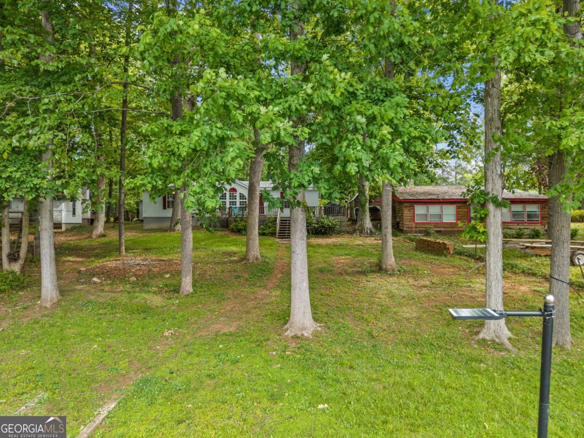 194 Phillips Road Eatonton, GA 31024 - Photo 7 of 57 a view of a house with a backyard