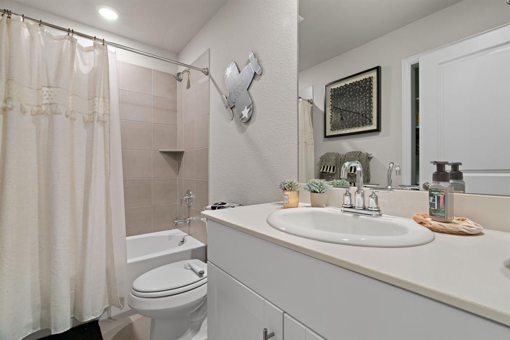3112 Kingsgarden Road Denton, TX 76207 - Photo 21 of 38 Full bathroom featuring a single vanity with an integrated sink, polished chrome faucet, and a large wall-mounted mirror
