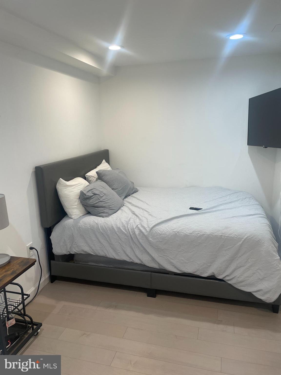 906 I Street Southeast, Unit 1 Washington, DC 20003 - Photo 13 of 19 a bedroom with a bed and chair