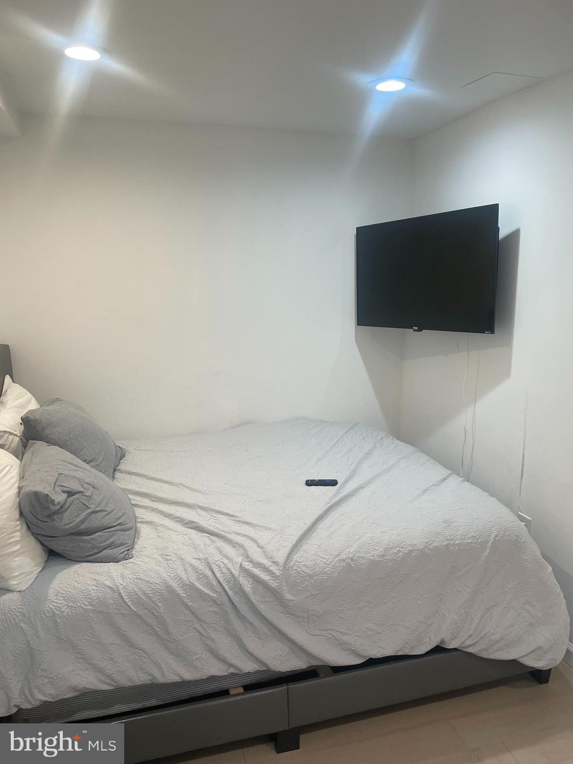 906 I Street Southeast, Unit 1 Washington, DC 20003 - Photo 14 of 19 a bedroom with a bed and a flat screen tv