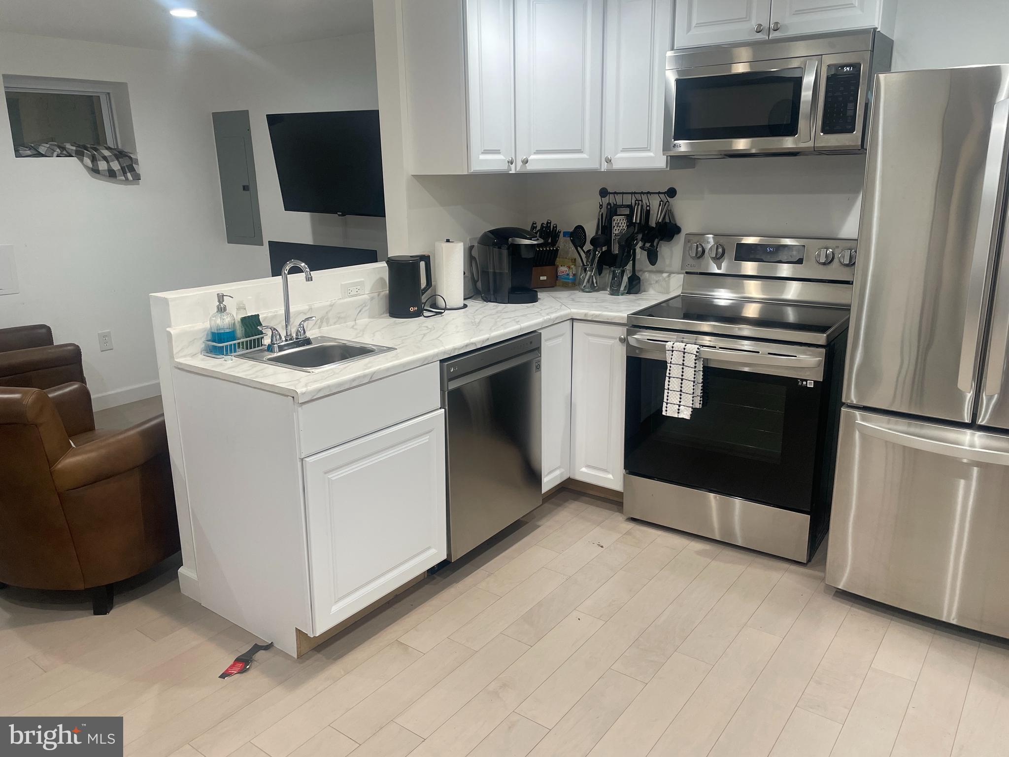 906 I Street Southeast, Unit 1 Washington, DC 20003 - Photo 3 of 19 a kitchen with stainless steel appliances a stove a microwave a sink and a microwave