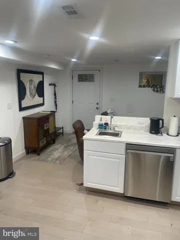 a room with a washing machine and a couch