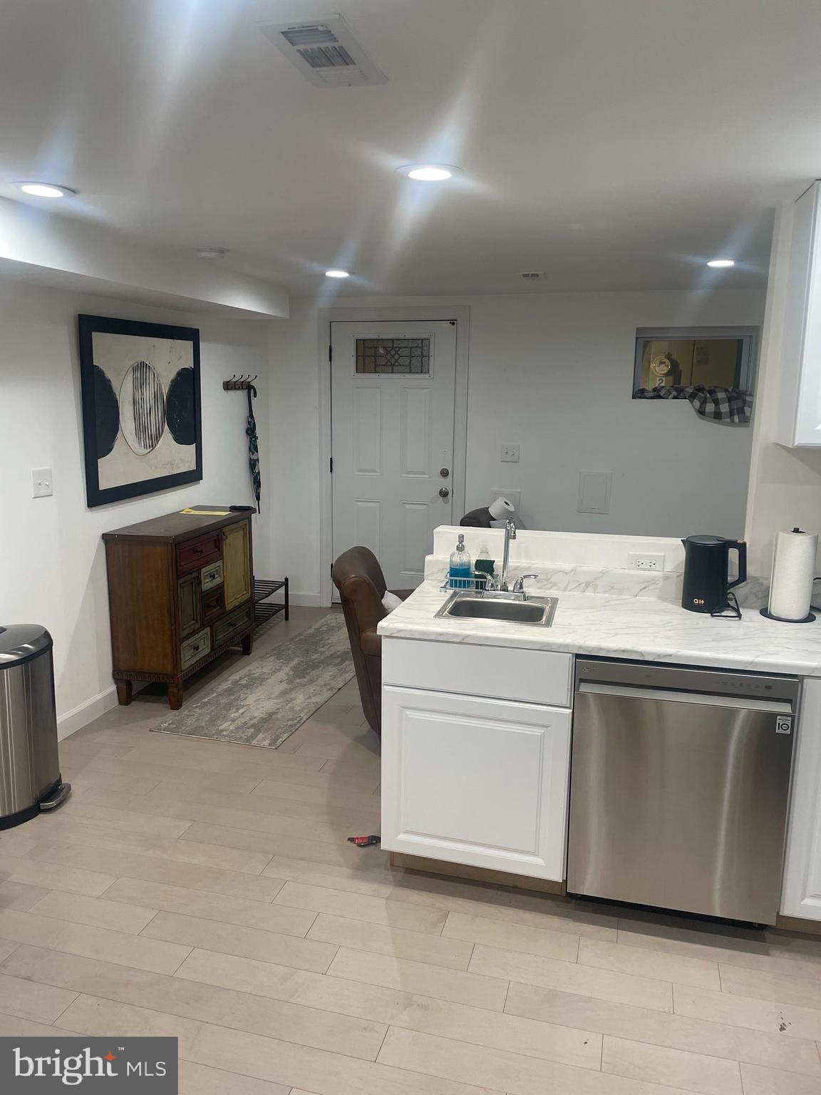 906 I Street Southeast, Unit 1 Washington, DC 20003 - Photo 7 of 19 a room with a washing machine and a couch