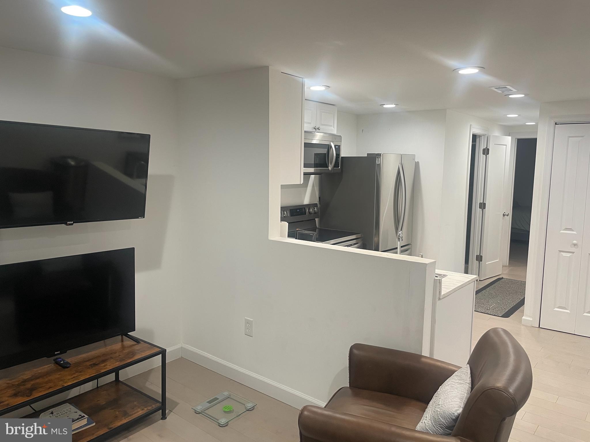 906 I Street Southeast, Unit 1 Washington, DC 20003 - Photo 9 of 19 a living room with furniture and a flat screen tv