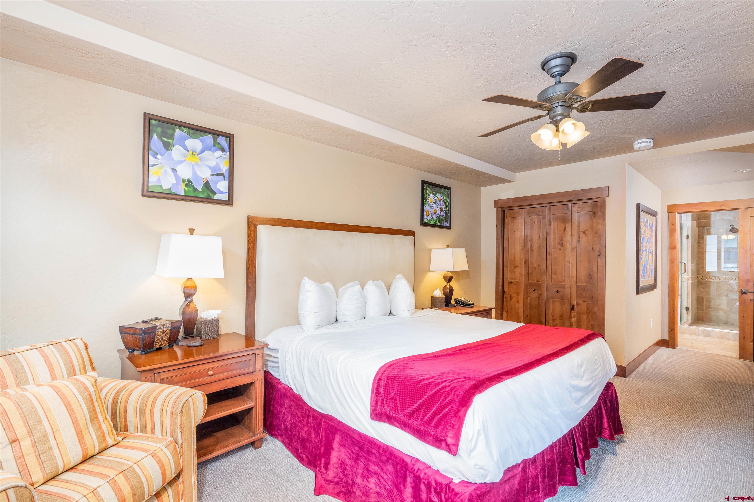 24 Sheol Street, Unit 204 Durango, CO 81301 - Photo 11 of 29 a bedroom with a bed and a chandelier