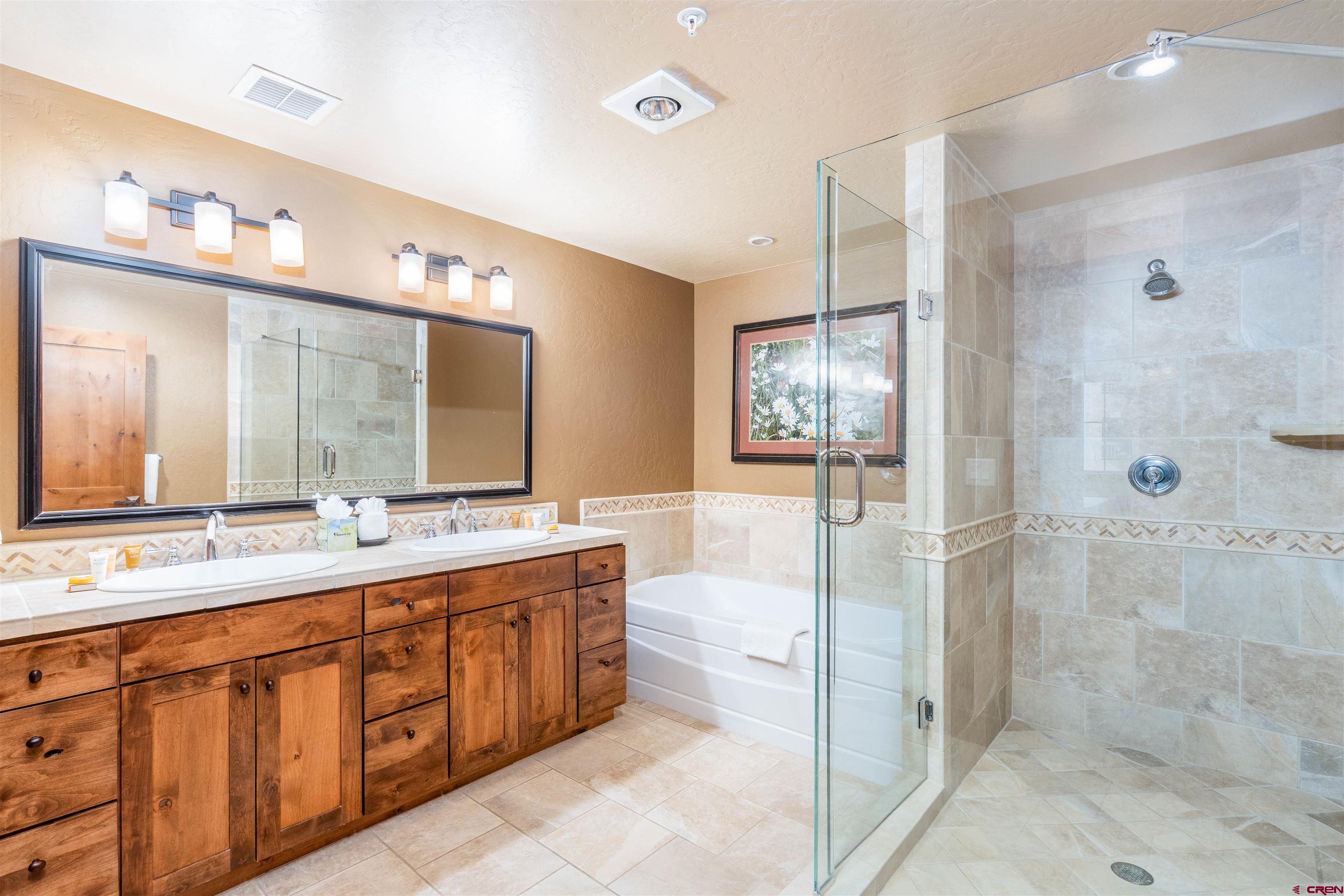 24 Sheol Street, Unit 204 Durango, CO 81301 - Photo 12 of 29 a spacious bathroom with a shower sink mirror and