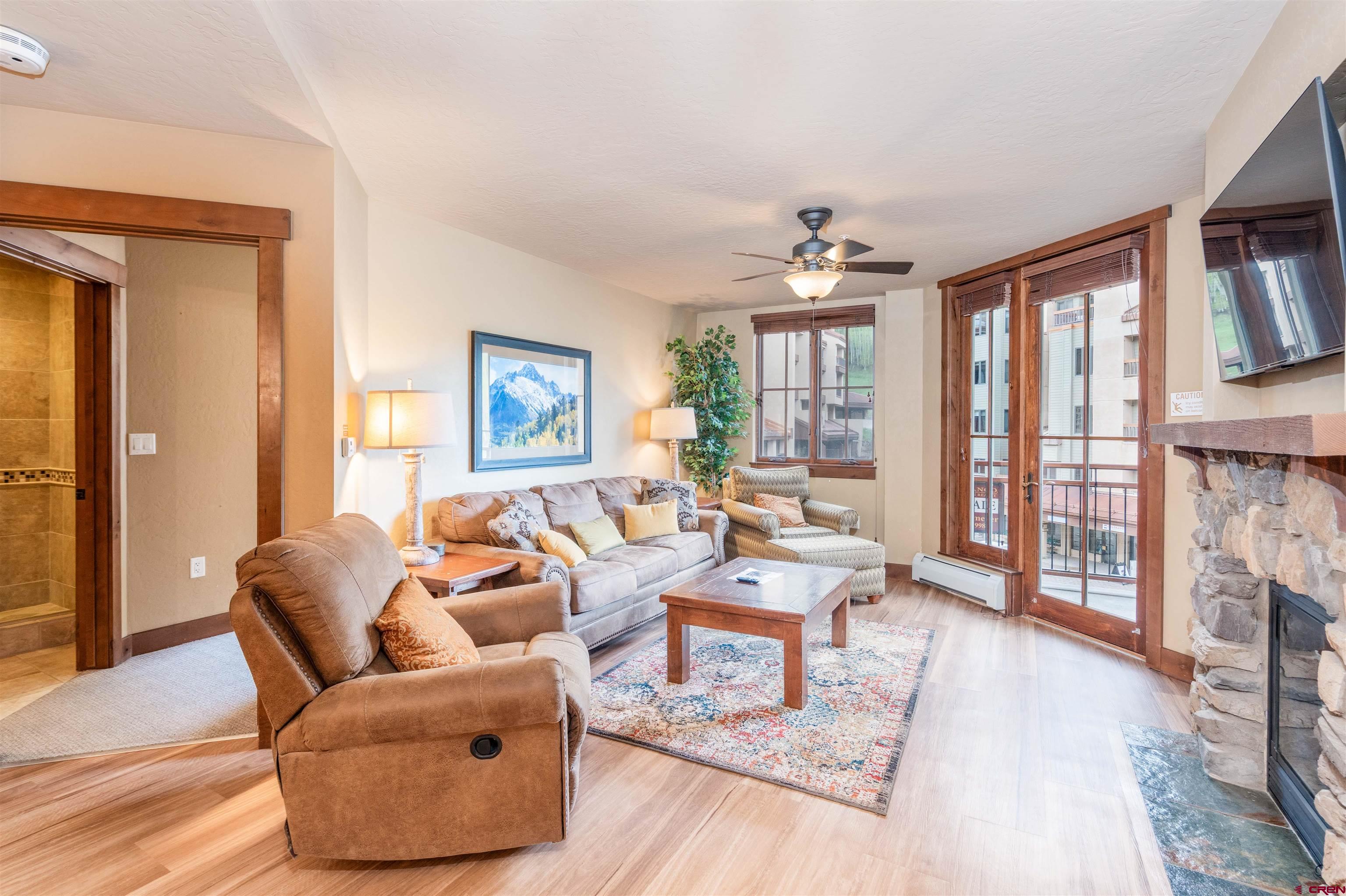 24 Sheol Street, Unit 204 Durango, CO 81301 - Photo 4 of 29 a living room with furniture large windows and wooden floor