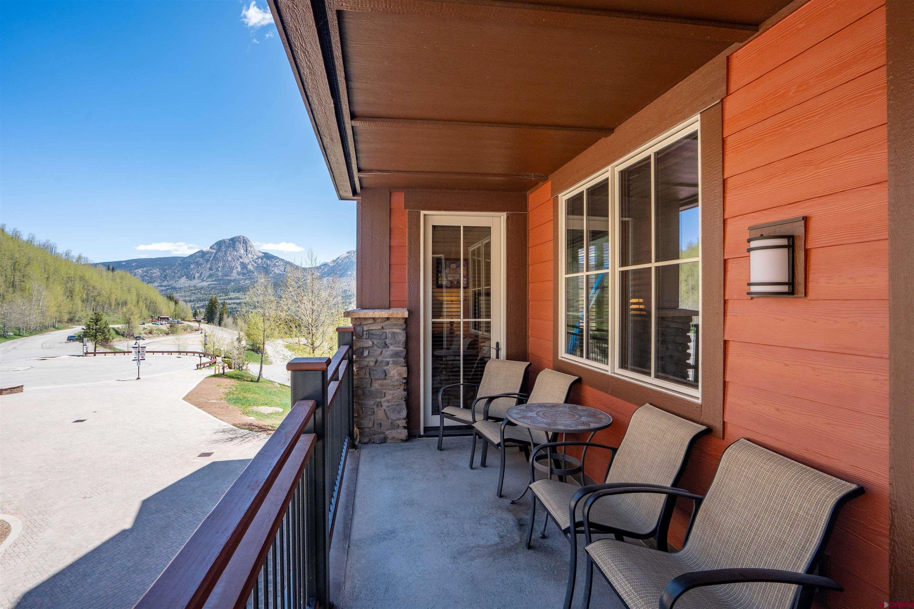 24 Sheol Street, Unit 204 Durango, CO 81301 - Photo 7 of 29 a view of a patio with a dining table and chairs with wooden floor and fence