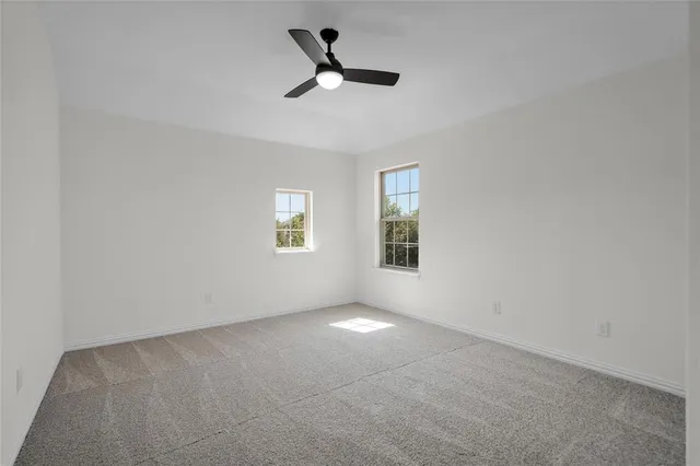 a bathroom with a granite countertop sink a toilet and a large mirror