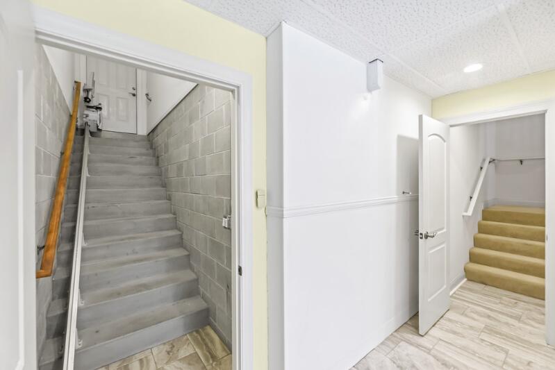 205 Kummrow Court Wales, WI 53183 - Photo 49 of 67 Lower level access to garage with chair