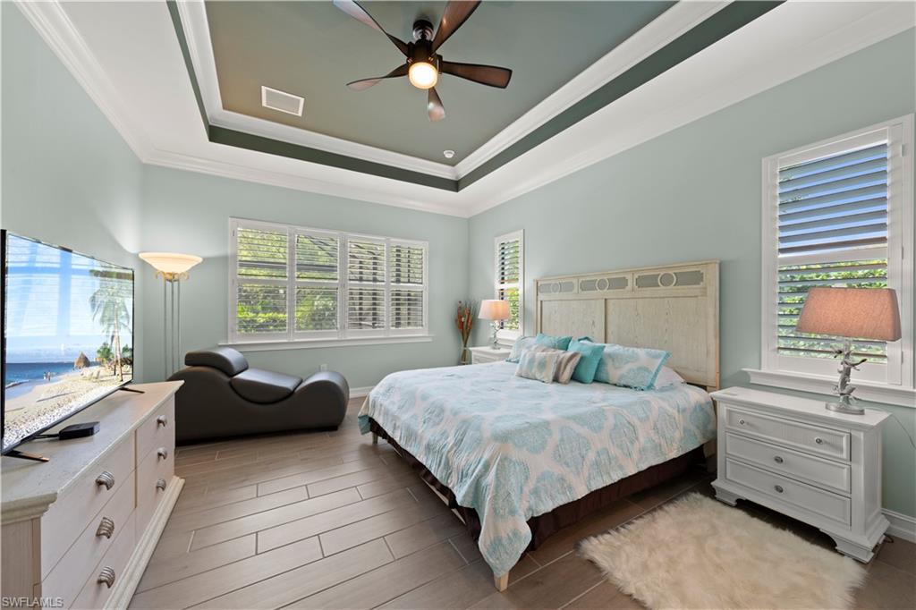 1608 Mockingbird Drive Naples, FL 34120 - Photo 14 of 29 a bedroom with a bed and a large window