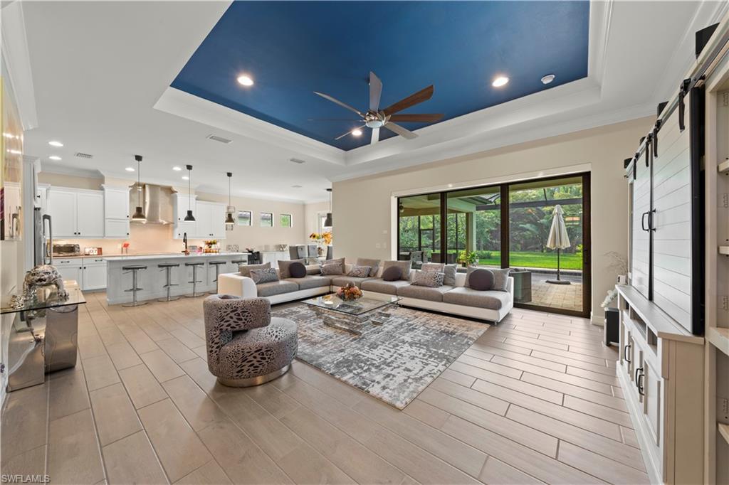 1608 Mockingbird Drive Naples, FL 34120 - Photo 2 of 29 a living room with lots of furniture and a large window