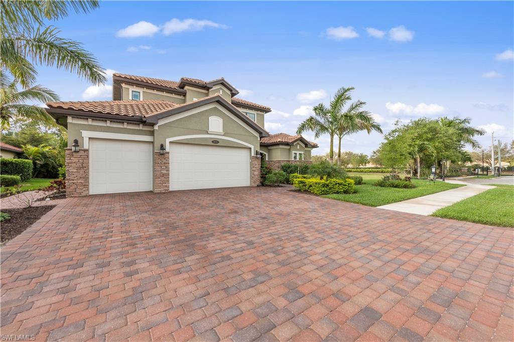 1608 Mockingbird Drive Naples, FL 34120 - Photo 27 of 29 a front view of a house with a yard and garage