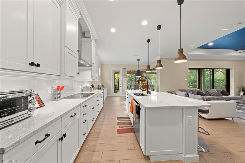 1608 Mockingbird Drive Naples, FL 34120 - Photo 3 of 29 a kitchen that has a lot of cabinets in it