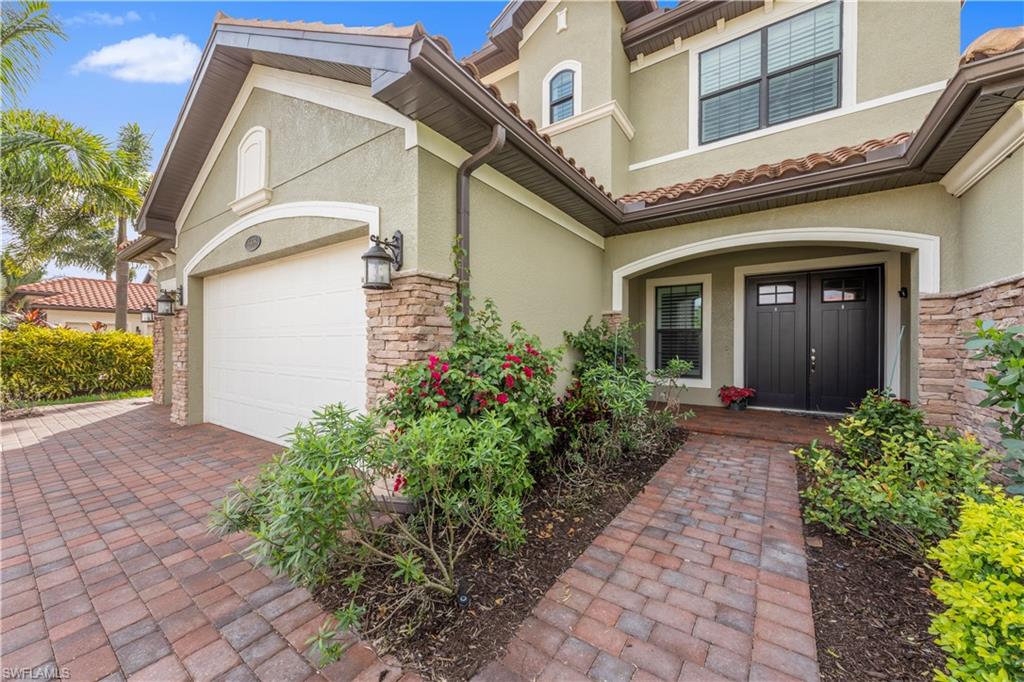1608 Mockingbird Drive Naples, FL 34120 - Photo 5 of 29 a front view of a house with garden