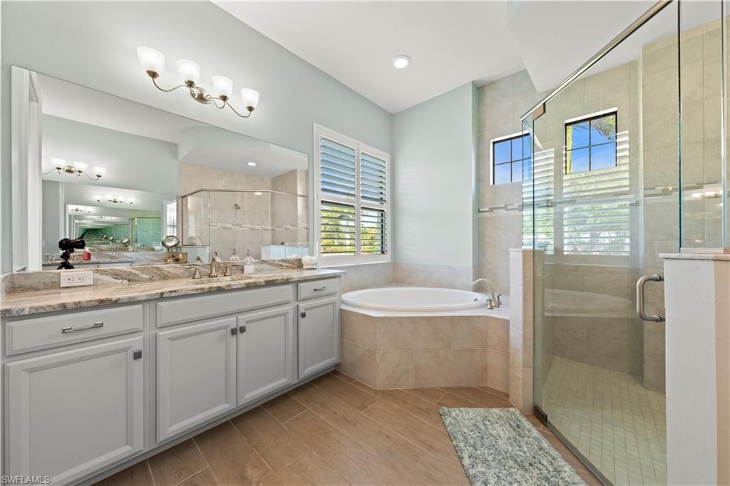 1608 Mockingbird Drive Naples, FL 34120 - Photo 7 of 29 a spacious bathroom with a double vanity sink a large mirror and shower
