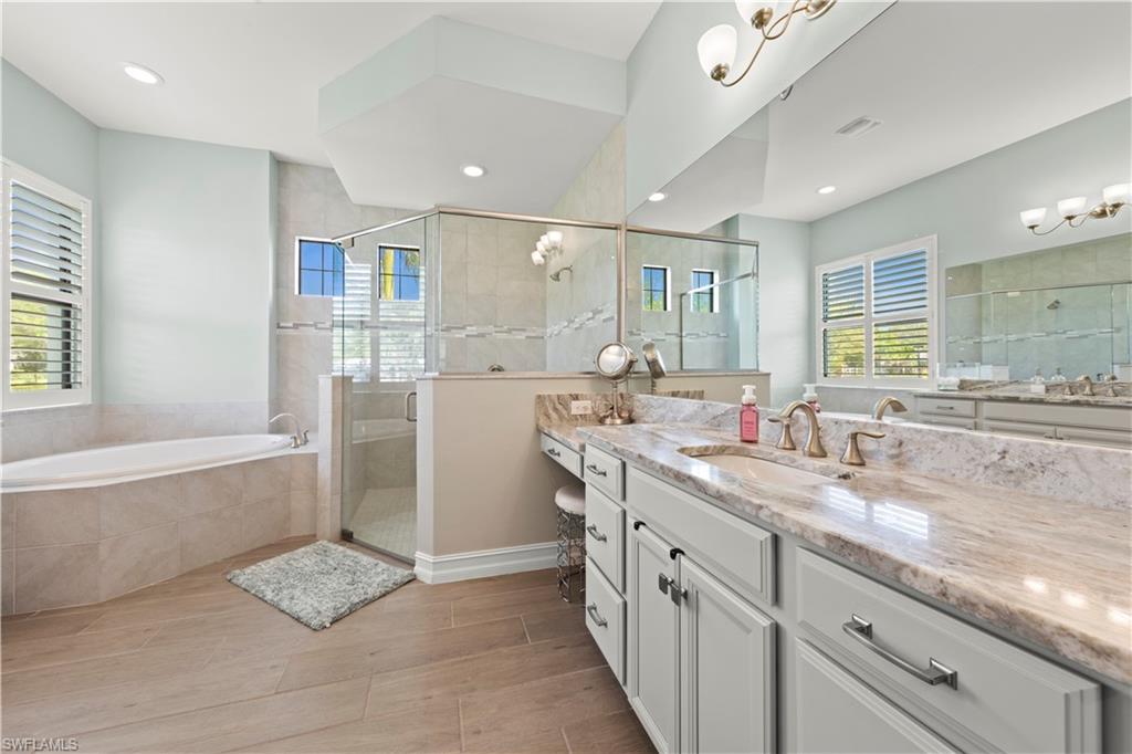1608 Mockingbird Drive Naples, FL 34120 - Photo 10 of 29 a bathroom with a tub sink and mirror