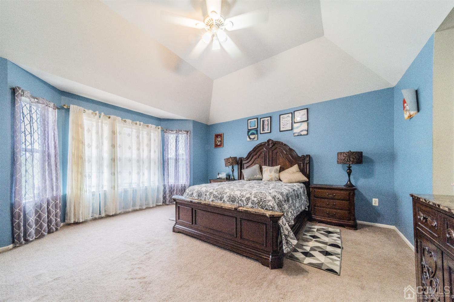 138 Disbrow Road Matawan, NJ 07747 - Photo 14 of 32 a spacious bedroom with a bed window and a chandelier
