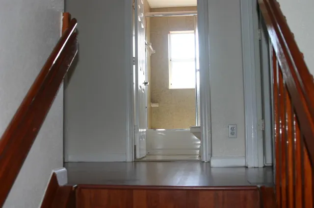 a bathroom with a granite countertop window and a shower