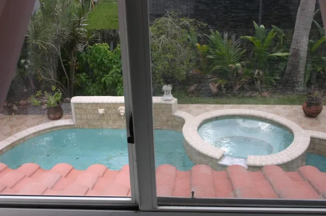 a view of a backyard with wooden fence