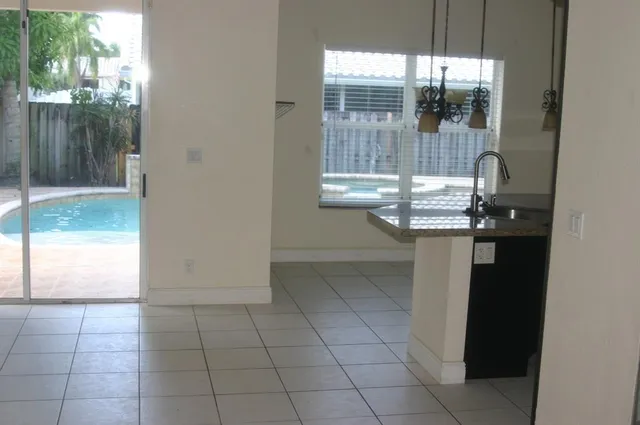 a kitchen with stainless steel appliances granite countertop a sink and a refrigerator