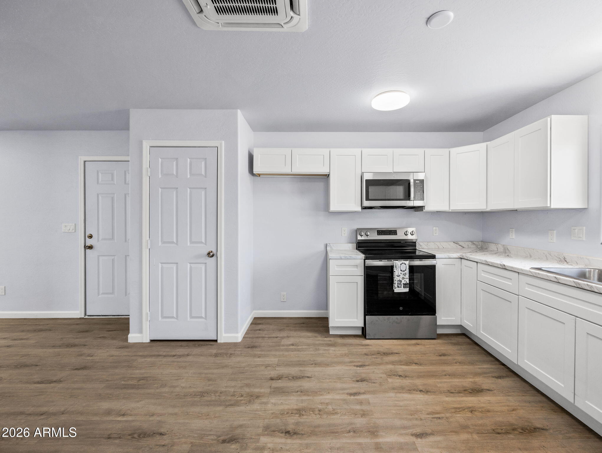 18278 Frontier Road Peeples Valley, AZ 86332 - Photo 17 of 31 a kitchen with granite countertop a stove top oven and sink