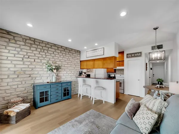 a living room with furniture and kitchen view