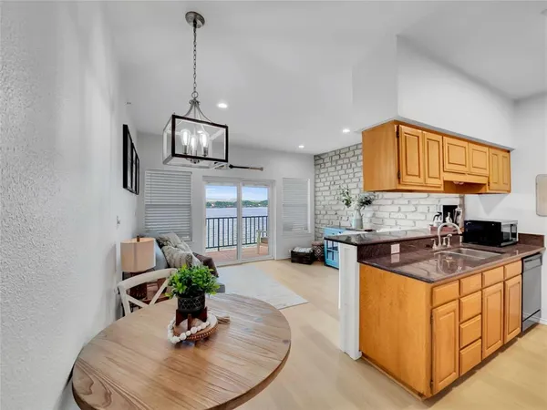 a living room with a fireplace furniture a rug and a window