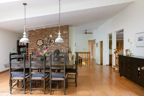 a very nice looking room with wooden floor and furniture