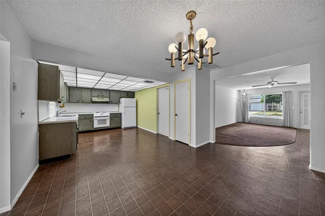 a view of a kitchen center island wooden floor and a ceiling fan