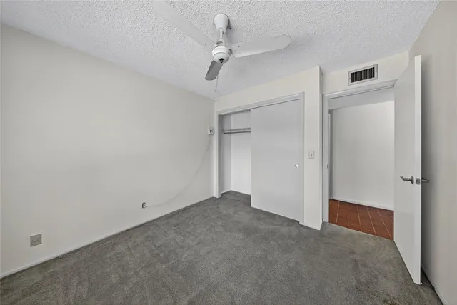 a view of a room with a ceiling fan
