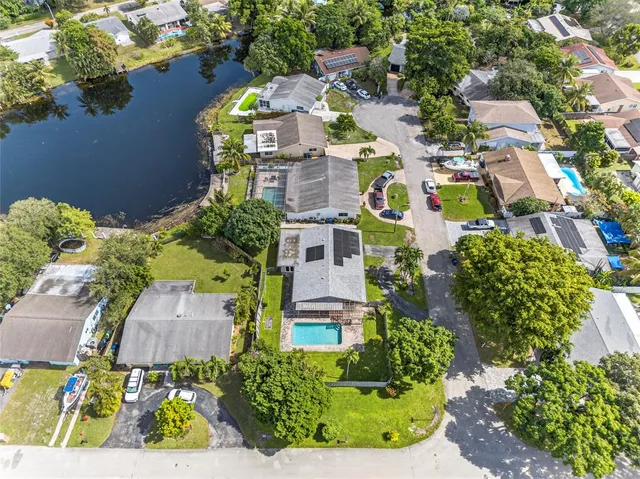 an aerial view of residential houses with outdoor space and street view
