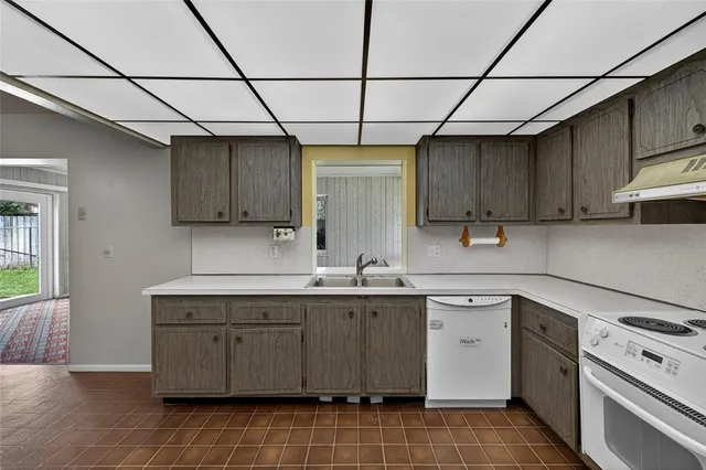 a kitchen with a sink stove and cabinets