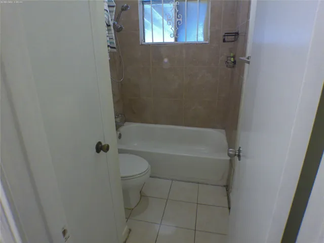 a white bath tub sitting next to a toilet