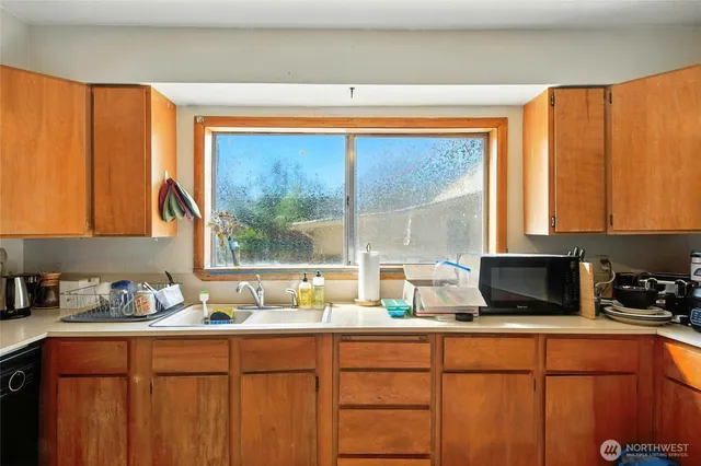 a kitchen with a window a sink and cabinets