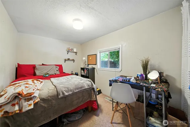 a bedroom with a bed and a table