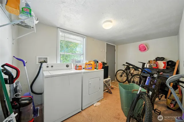 a storage utility room with washer and dryer