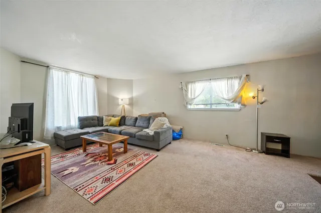 a bedroom with furniture and a window