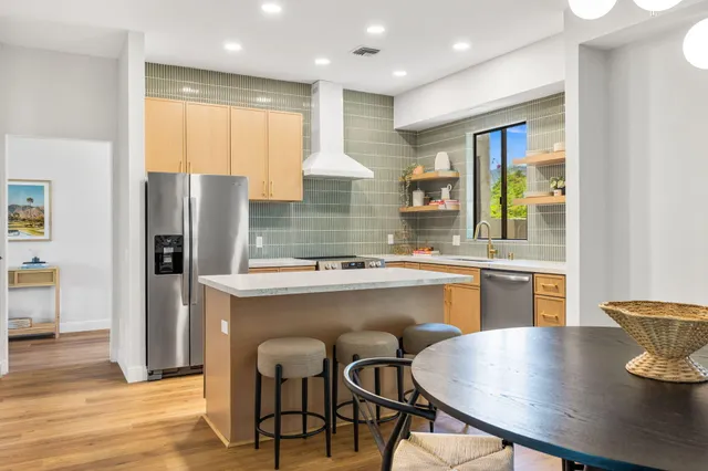 a dining room with furniture potted plants and wooden floor