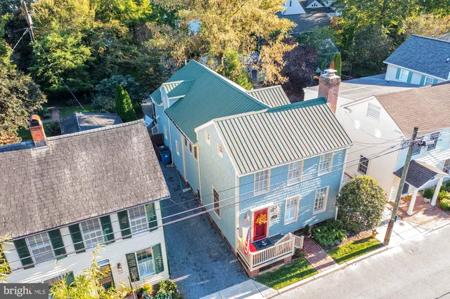 a view of a roof deck with couches and wooden floor