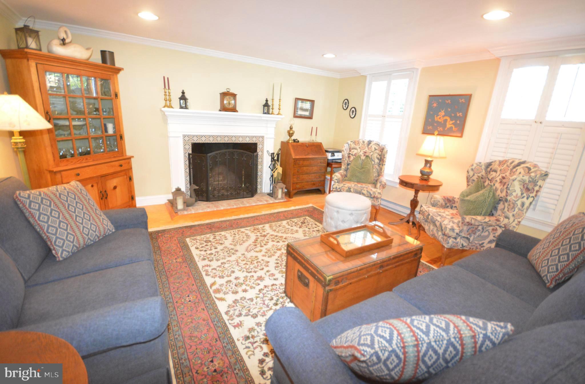 106 Grace Street St. Michaels, MD 21663 - Photo 21 of 57 a living room with furniture and a fireplace