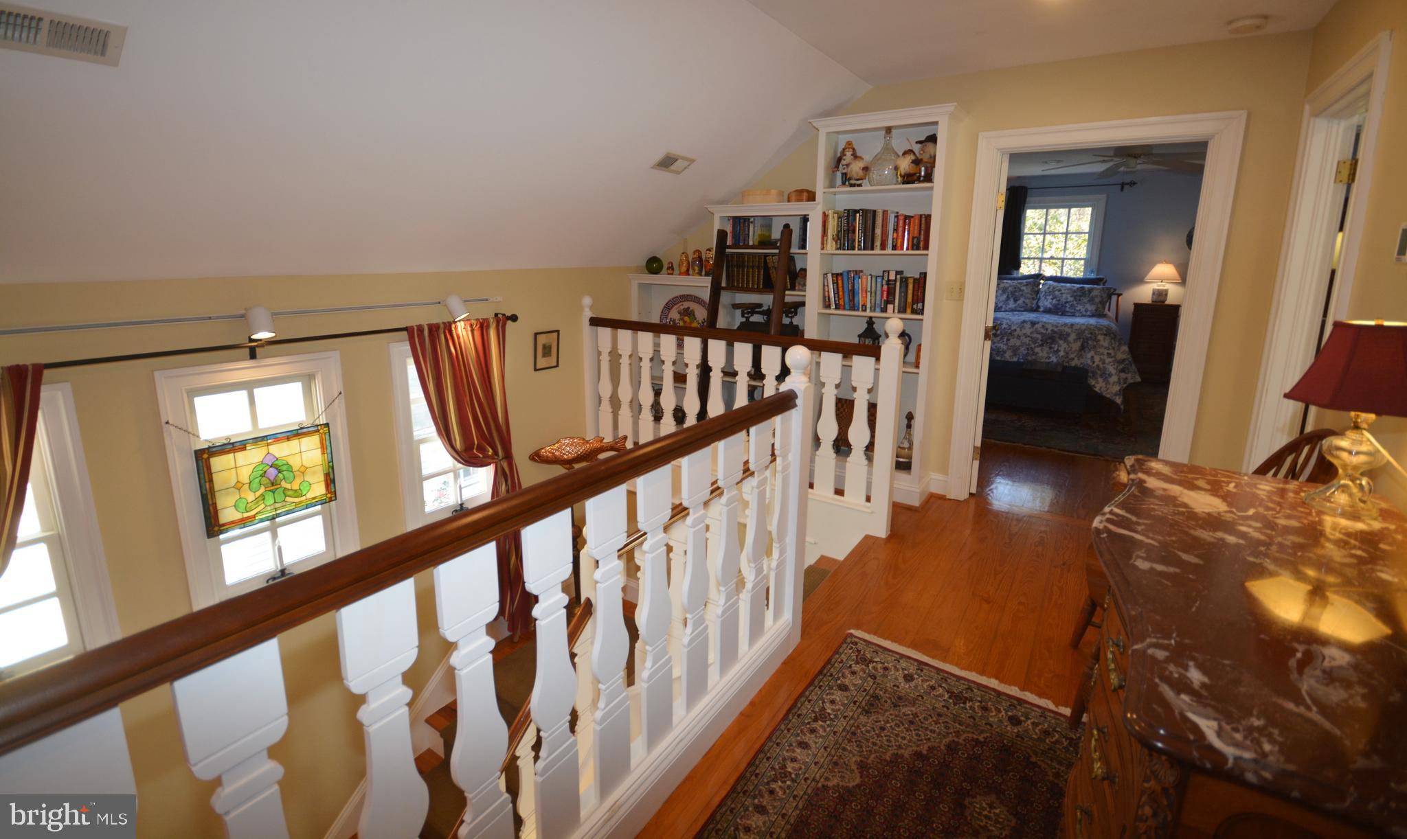 106 Grace Street St. Michaels, MD 21663 - Photo 38 of 57 a view of staircase with lots of frames on wall and a window