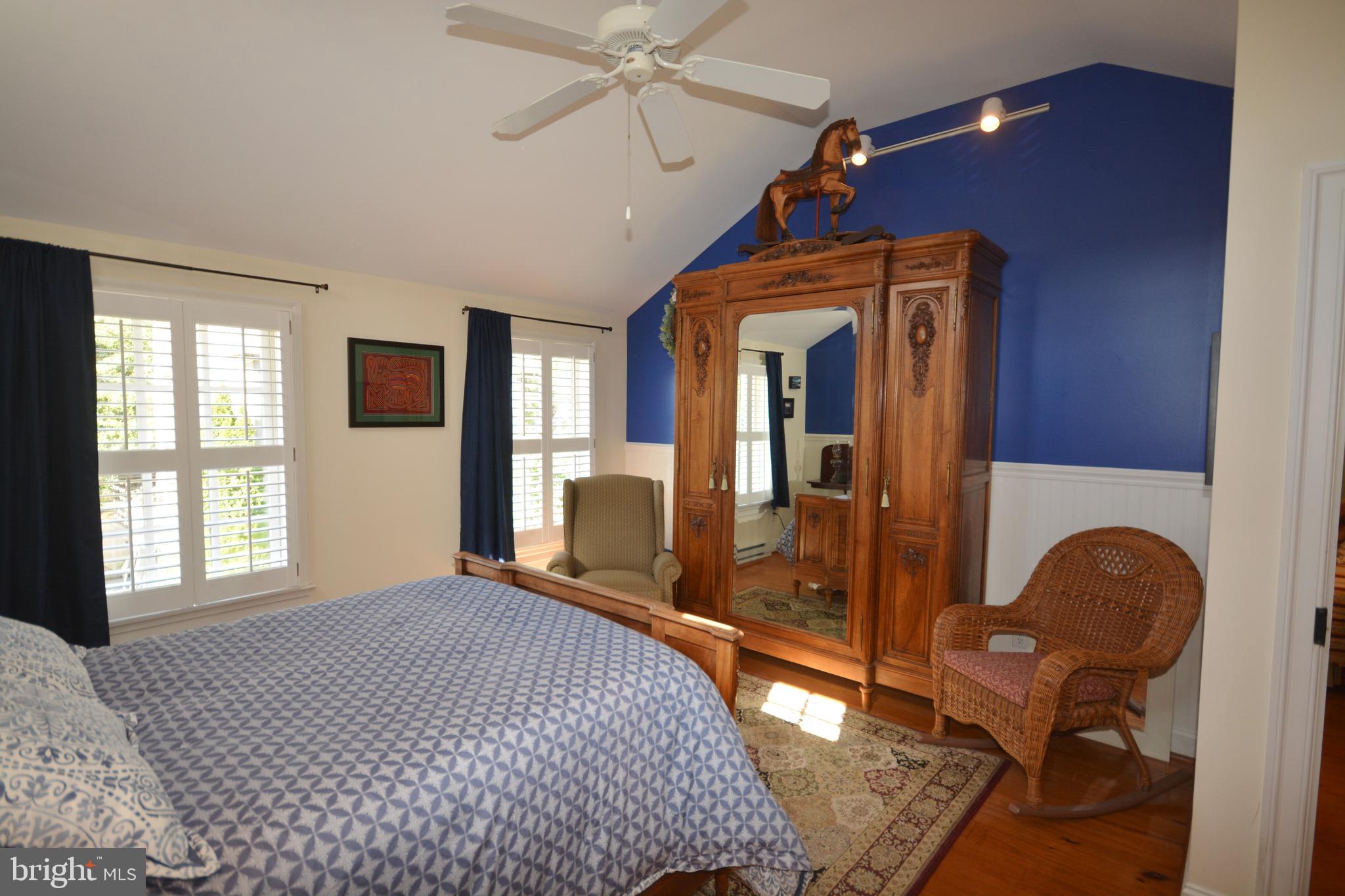 106 Grace Street St. Michaels, MD 21663 - Photo 44 of 57 a bedroom with a bed and wooden floor